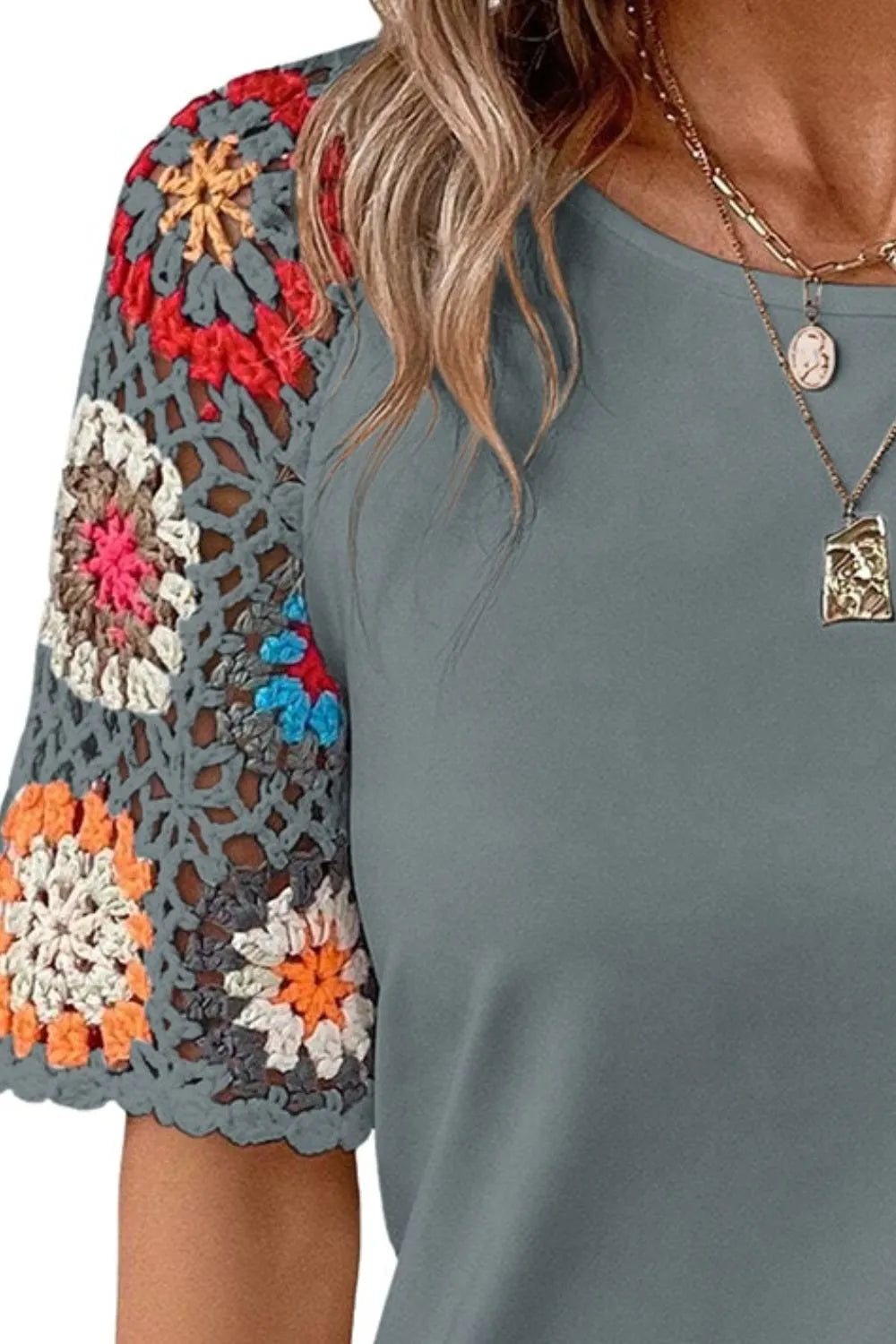Geometric print round neck short sleeve blouse from Trendsi, featuring a stylish pattern and comfortable fit.