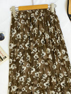 Floral print elastic waist midi skirt from Trendsi, featuring a flowy design and vibrant floral pattern.
