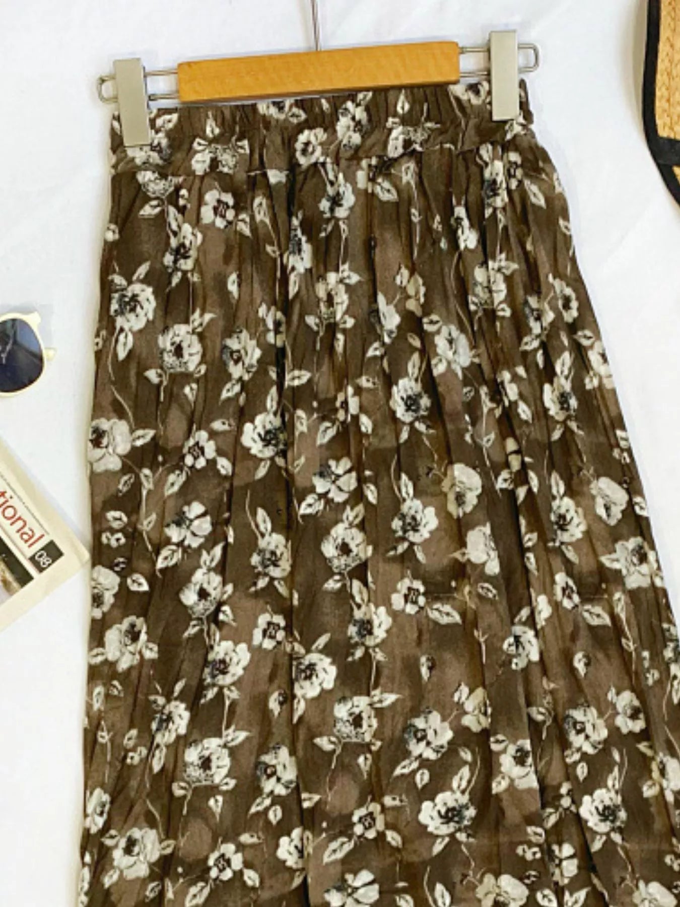 Floral print elastic waist midi skirt from Trendsi, featuring a flowy design and vibrant floral pattern.