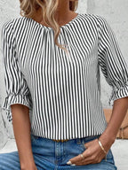 Women's striped ruffled round neck half sleeve blouse from Trendsi, featuring a stylish design with ruffles and a classic round neckline.