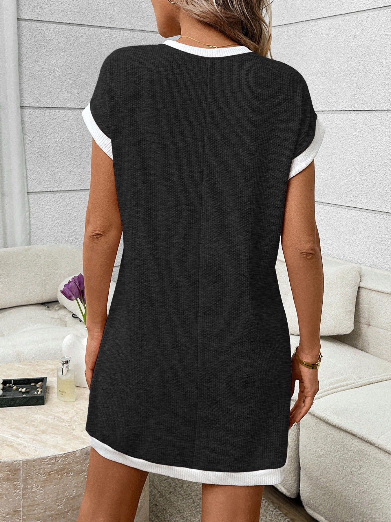 Ribbed knit mini dress with contrast trim and functional pocket, trendy dress by Trendsi, shown on a model.