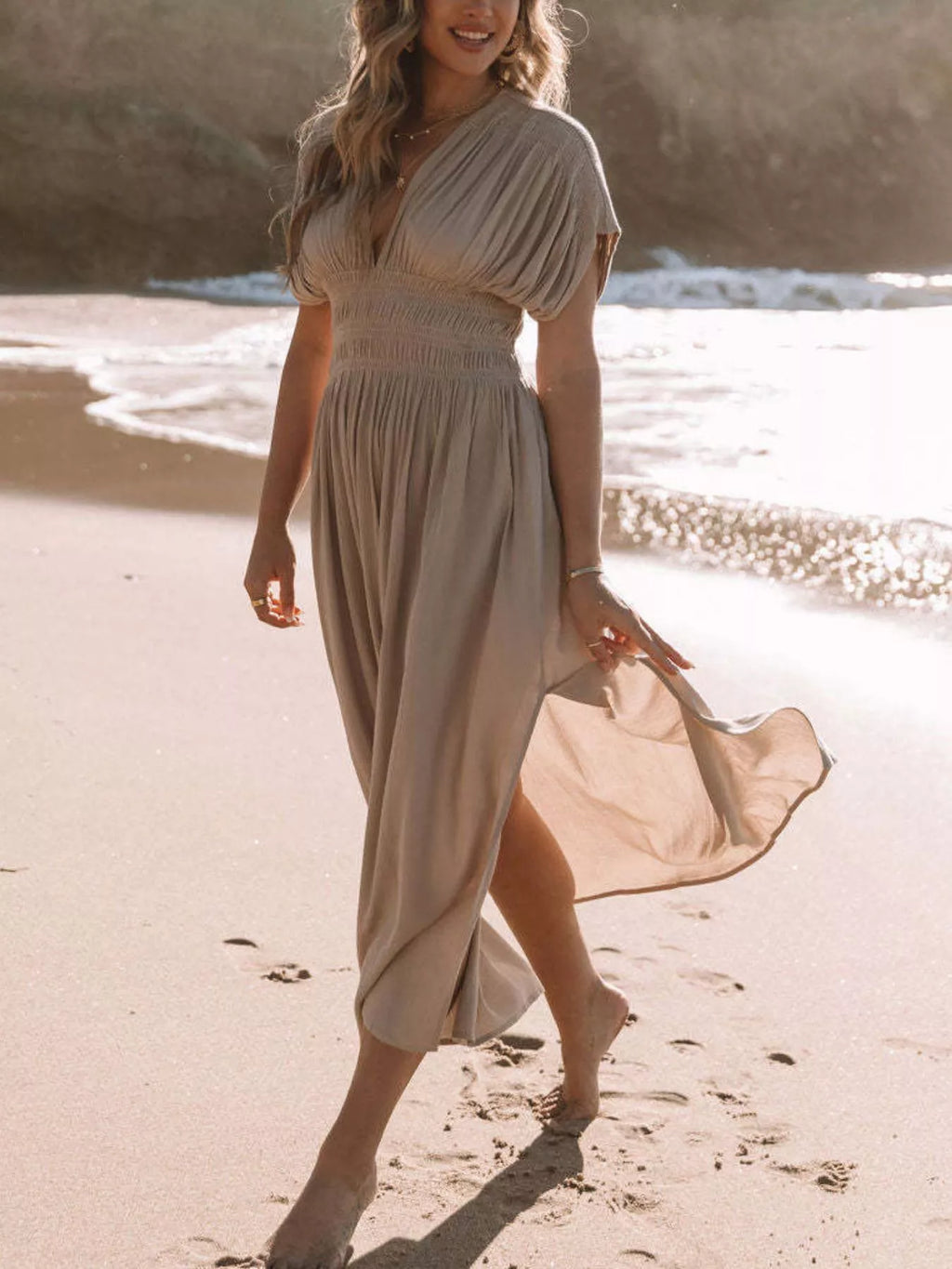 Plus size maxi dress with slit V-neck, smocked waist, and flowing fabric from Trendsi, perfect for stylish summer occasions.