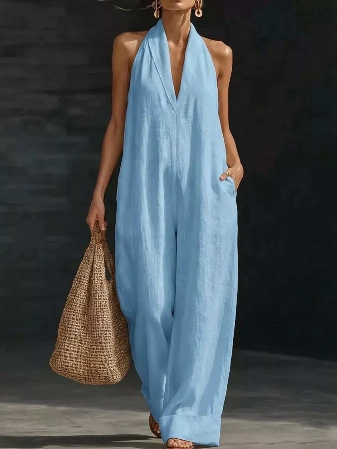 Trendsi halter neck wide-leg jumpsuit in beige fabric, featuring a fitted bodice and flowing wide-leg pants.