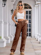 High-waisted cargo denim jeans from Plush Fashion Shop with multiple pockets and a relaxed fit, displayed on a white background.