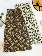 Floral print elastic waist midi skirt by Trendsi, showcasing flowing fabric and vibrant flower patterns perfect for spring and summer.