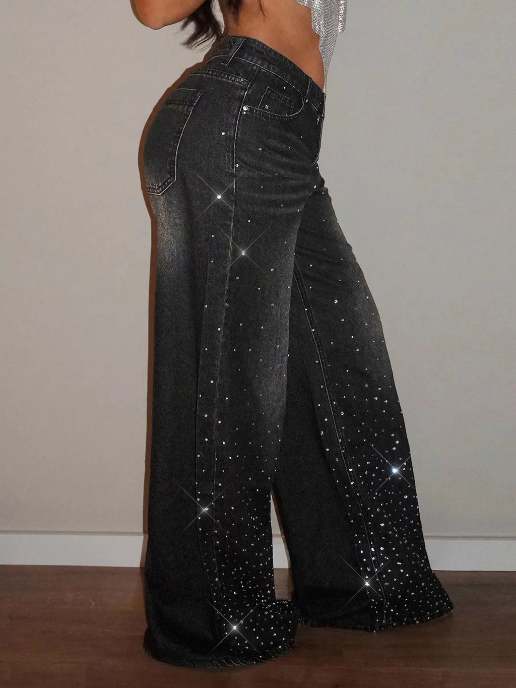 Rhinestone wide-leg jeans from Trendsi featuring embellished rhinestones along the waistband and flowing wide-leg silhouette.