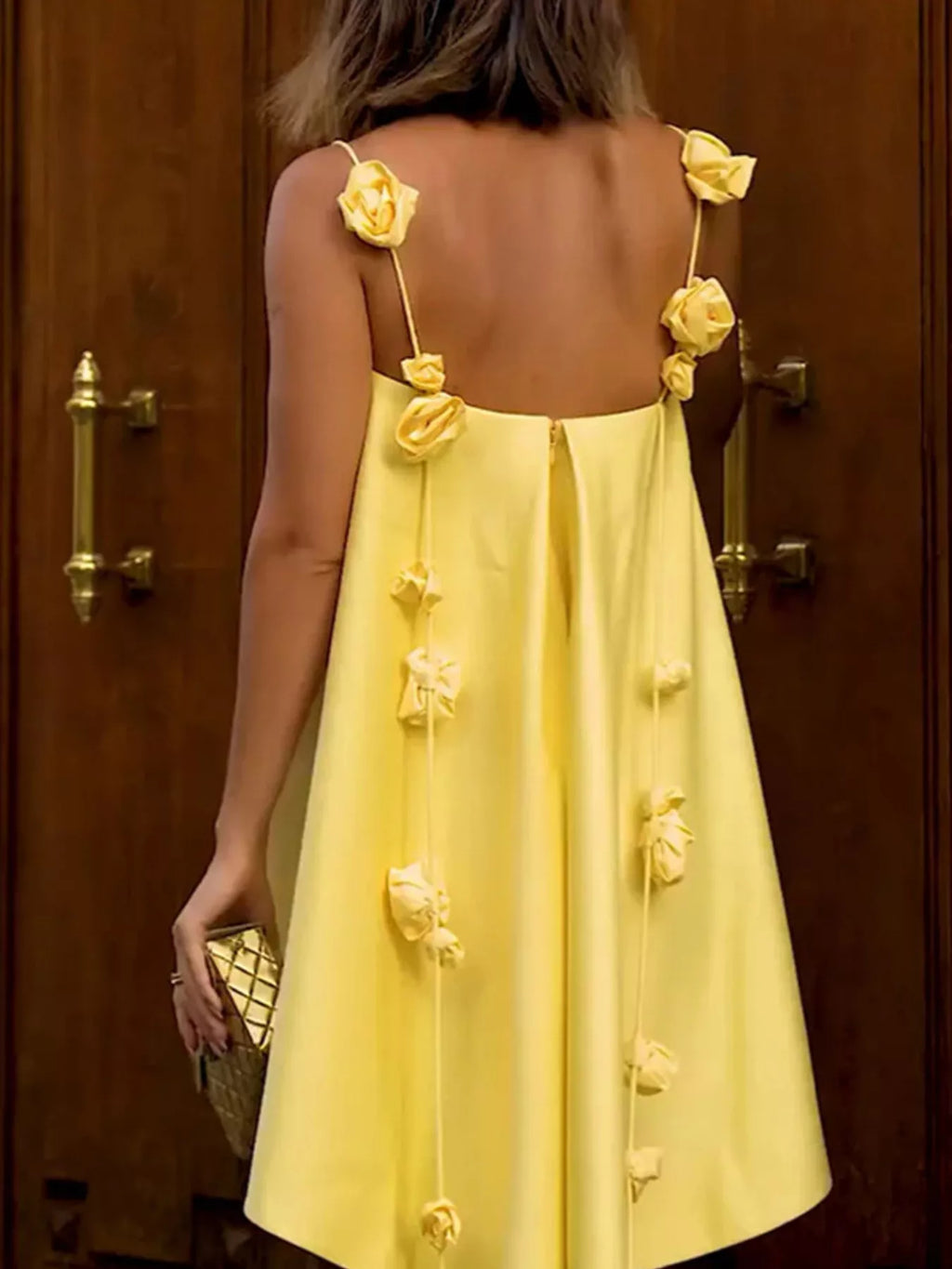 Floral strap mini A-line dress by Trendsi featuring a fitted bodice, flared skirt, and thin shoulder straps.