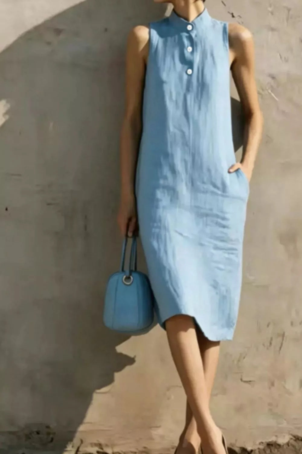 Casual sleeveless midi dress with button details from Trendsi, featuring a relaxed fit and lightweight fabric in a stylish design.