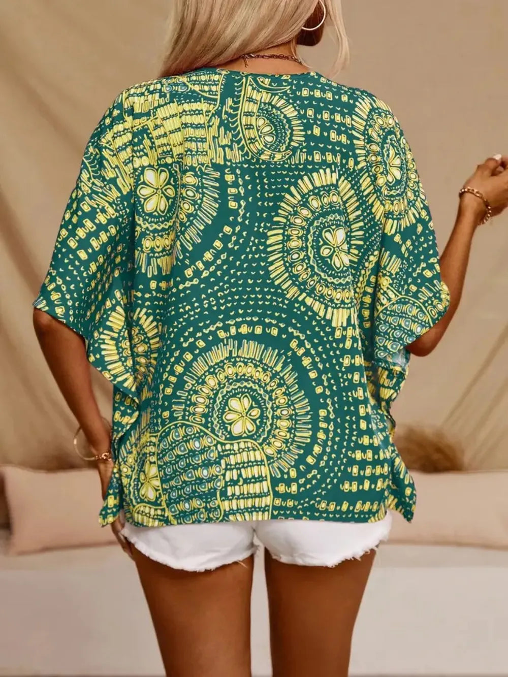 Women's printed V-neck half sleeve casual top by Trendsi, soft stretch fabric, stylish office blouse with colorful pattern.