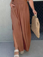 Plus size maxi dress with V-neck, slit front, smocked waist, trendy design by Trendsi, full-length, comfortable and stylish.