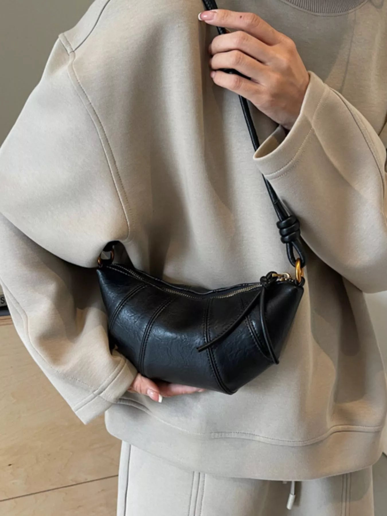 Croissant-shaped crossbody bag by Trendsi with a soft, realistic croissant design and adjustable strap, perfect for casual style.