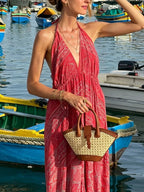 Tiered halter neck maxi dress by Trendsi featuring a flowing layered design and elegant halter neckline, perfect for summer occasions.