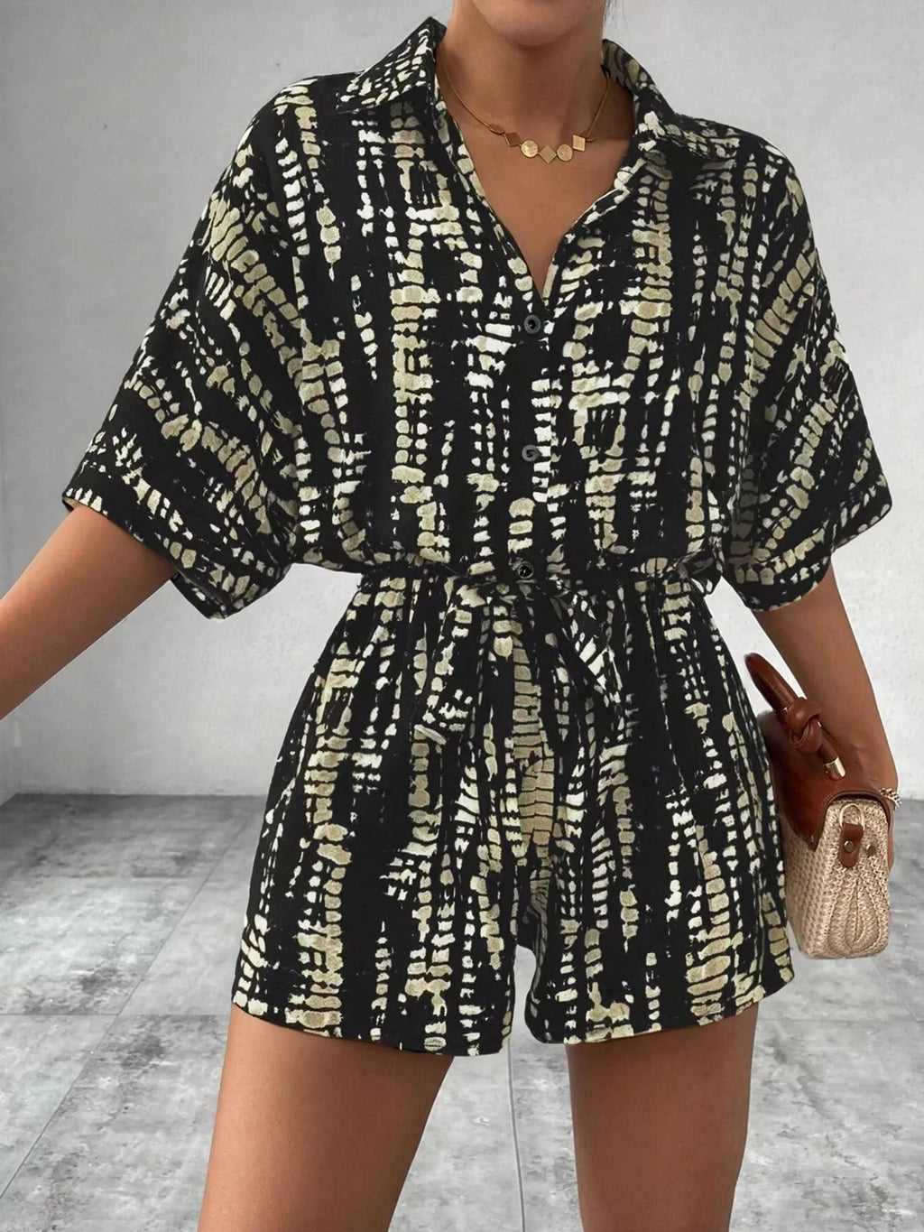Striped button-up belted romper by Trendsi featuring a relaxed fit, front buttons, and a waist belt, perfect for casual summer wear.