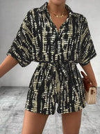 Striped button-up belted romper by Trendsi featuring a relaxed fit, front buttons, and a waist belt, perfect for casual summer wear.