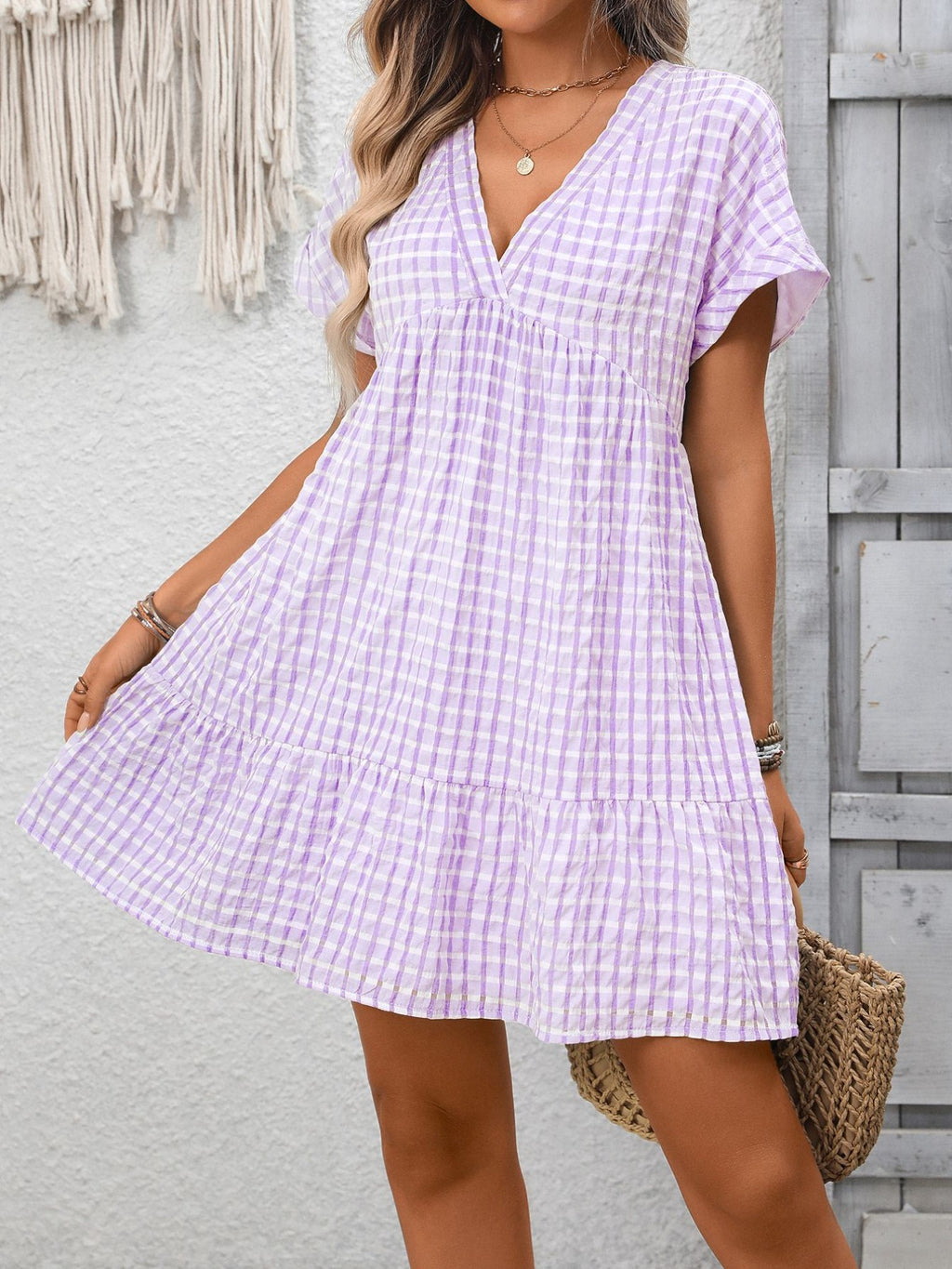 Lightweight plaid V-neck mini dress from Trendsi featuring ruffle hem and seasonal fashion style.
