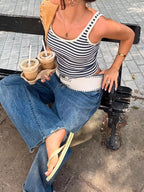 Striped scoop neck tank top from Trendsi featuring horizontal black and white stripes and a relaxed fit.