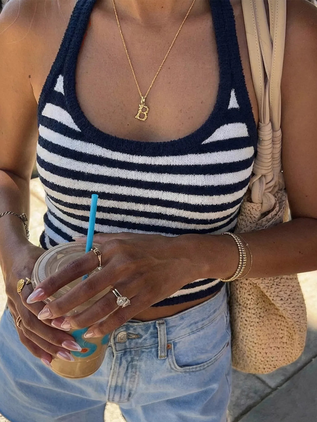 Striped halter neck cami top by Trendsi featuring a stylish halter design and colorful vertical stripes.