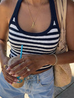 Striped halter neck cami top by Trendsi featuring a stylish halter design and colorful vertical stripes.