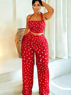 Polka dot halter neck cami with fringe trim pants set by Trendsi, featuring a stylish polka dot pattern and fashionable fringe details.