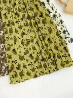 Floral print elastic waist midi skirt from Trendsi, featuring a flowy design and vibrant flower pattern.