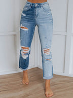 Distressed blue jeans with front and back pockets, trendy denim from Trendsi, casual and stylish for everyday wear.