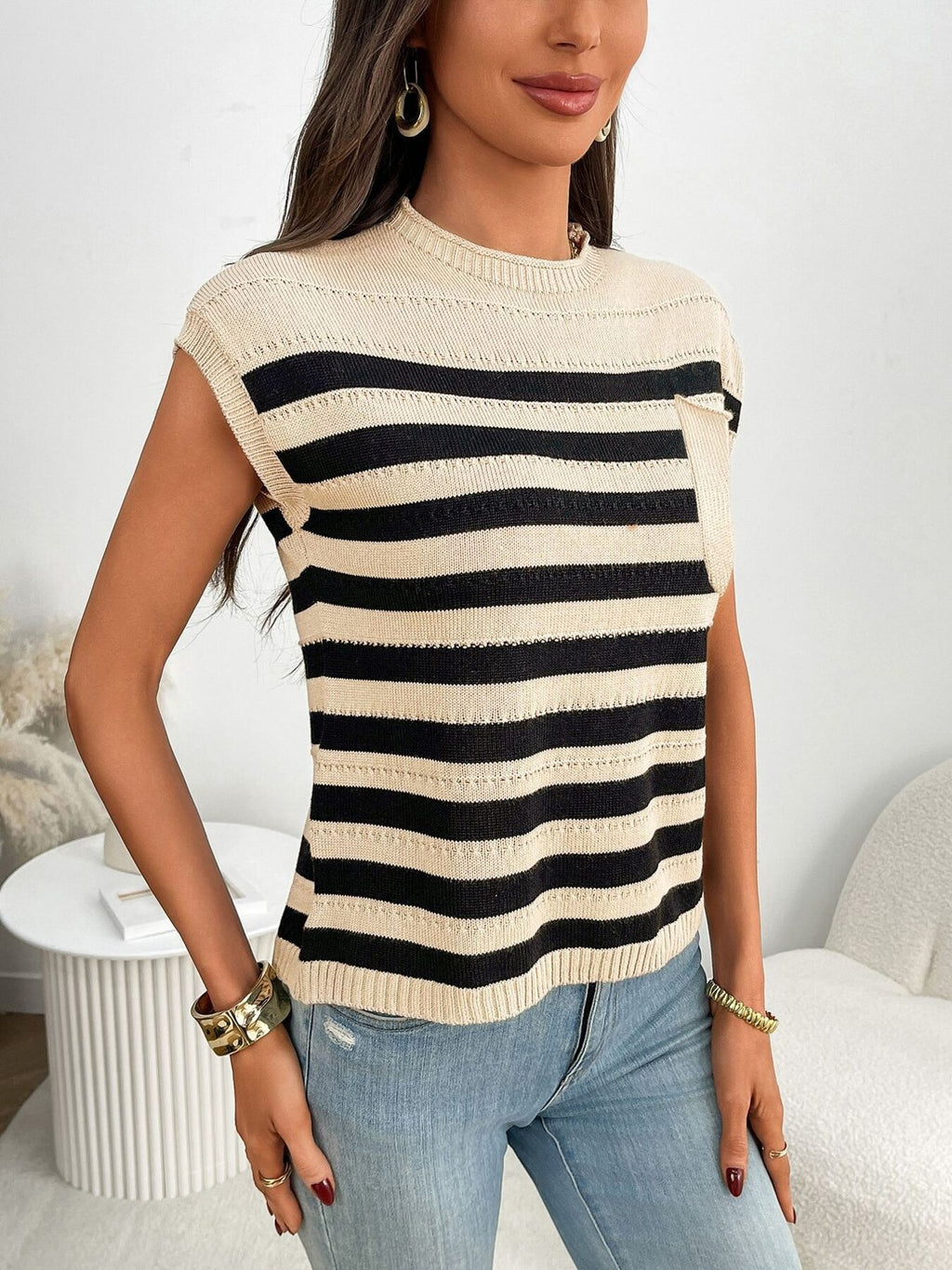 Women's striped knit cap sleeve sweater with pocket detail, trendy and comfortable, perfect for casual wear.