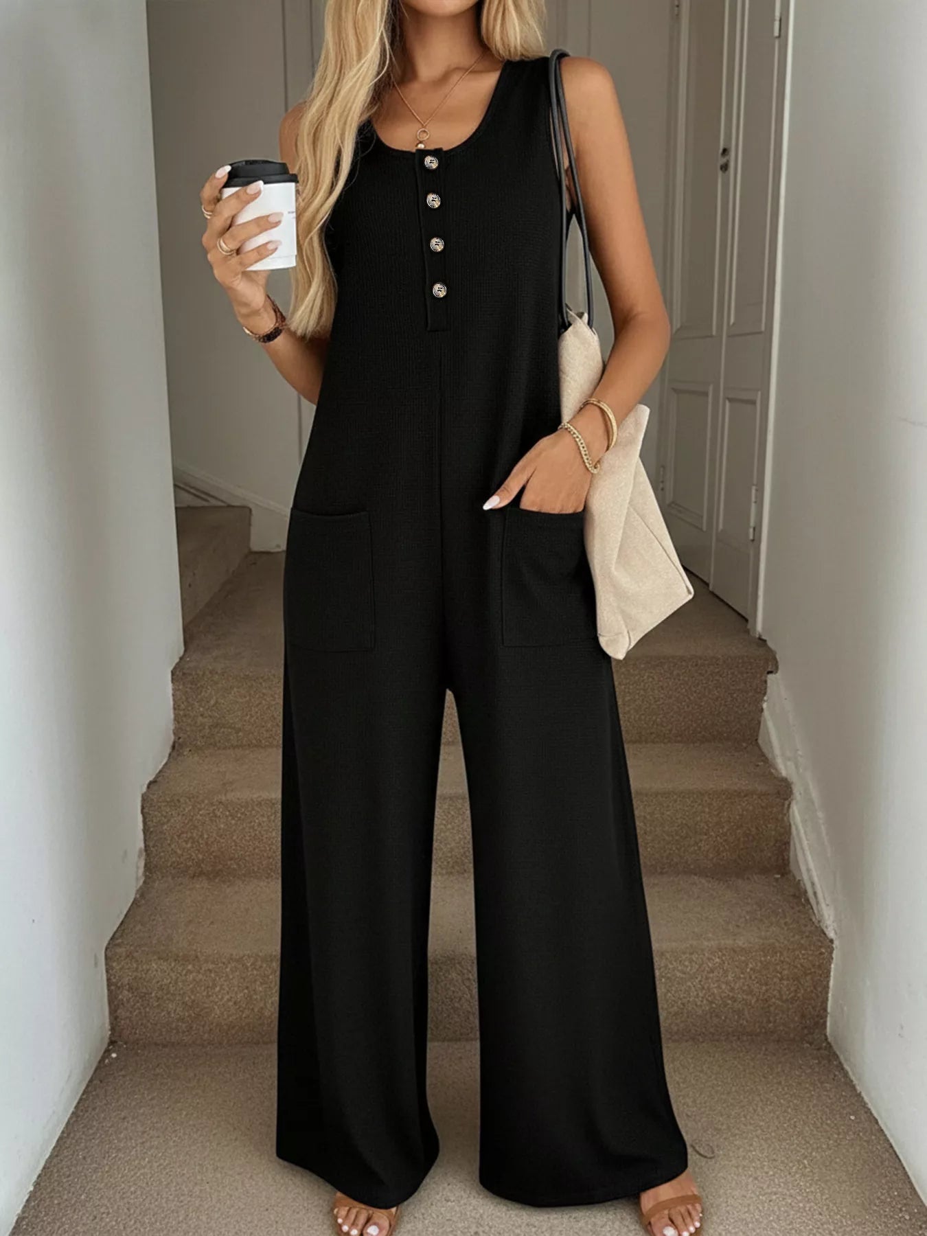 Sleeveless button-front wide-leg jumpsuit by Trendsi, featuring a comfortable and chic design with a stylish romper silhouette.