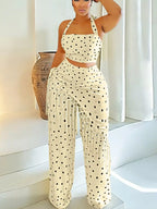 Polka dot halter neck cami with fringe trim pants set by Trendsi, featuring a stylish polka dot pattern and fashionable fringe details.
