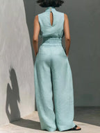 Sleeveless turtleneck top and wide-leg pants set by Trendsi, featuring a sleek, modern design in neutral fabric.