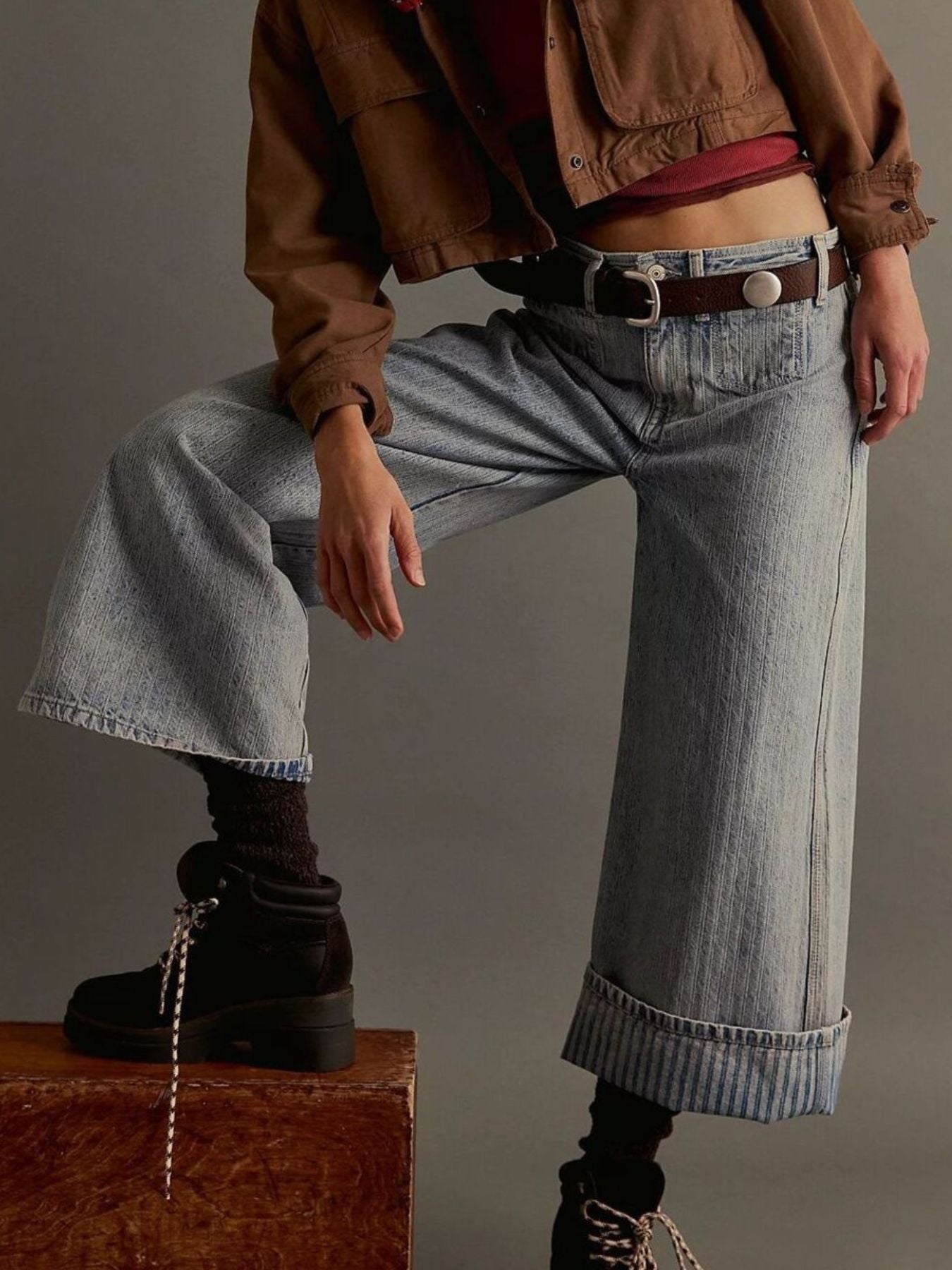 Pair of plush fashion shop wide-leg cropped denim jeans hanging on a rack, showcasing relaxed fit and stylish design.