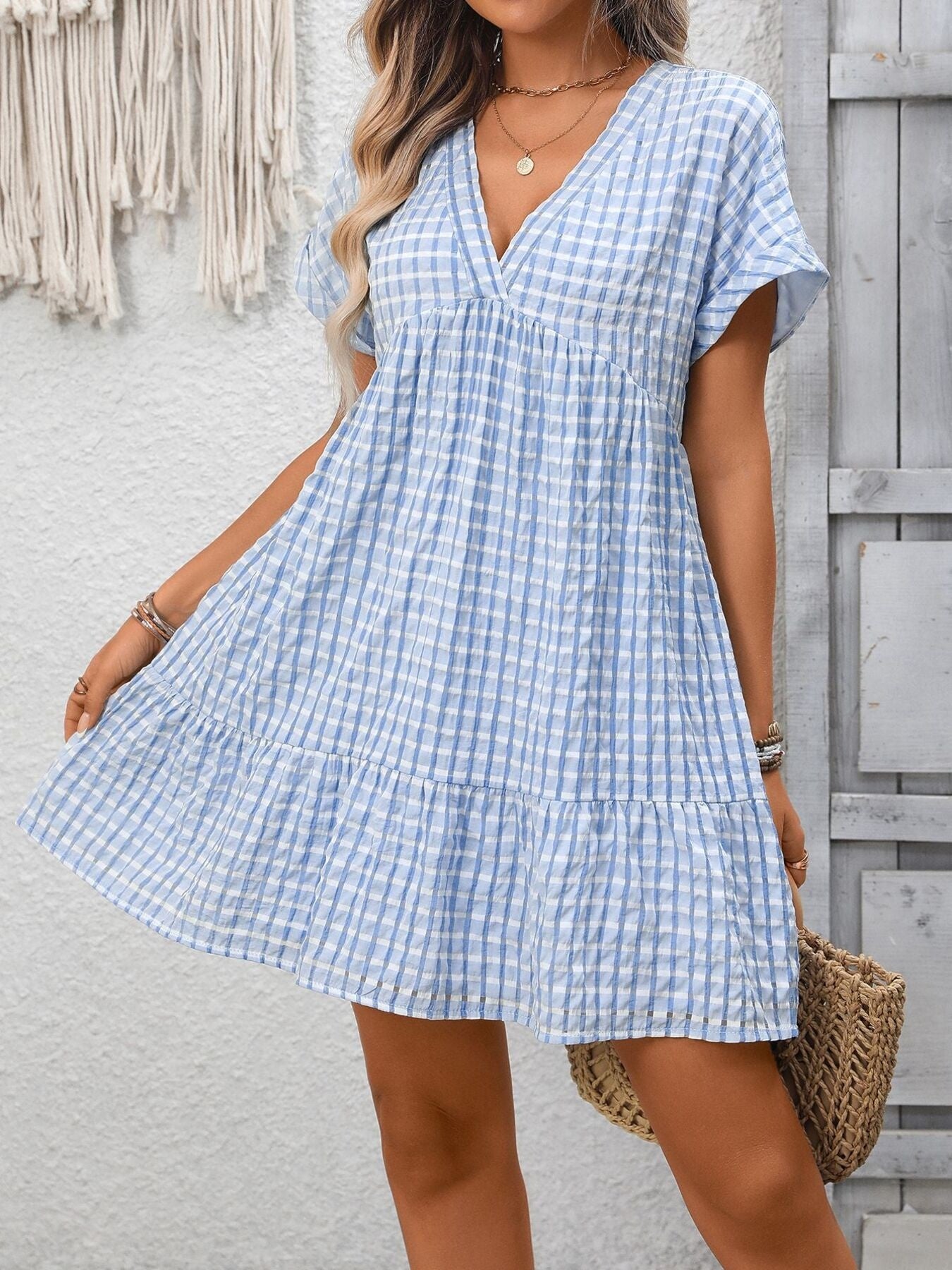 Lightweight plaid V-neck mini dress with ruffle hem from Trendsi, perfect for seasonal fashion and casual wear.
