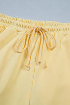 Trendsi half sleeve top and drawstring pants set in soft fabric, shown in a stylish relaxed fit, perfect for casual wear.