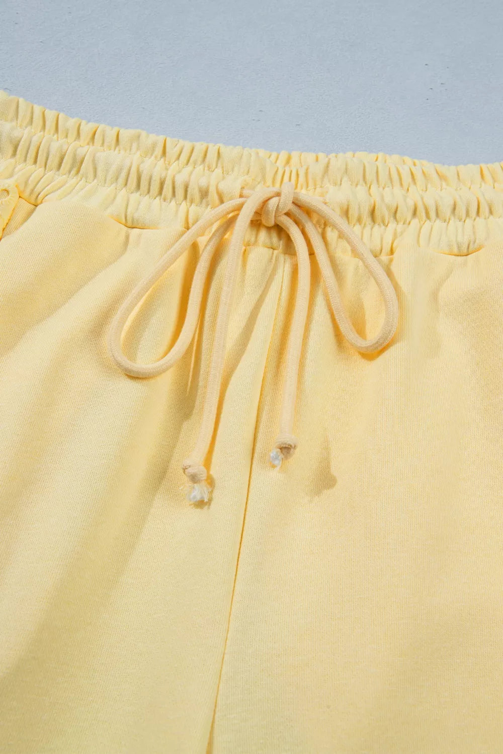 Trendsi half sleeve top and drawstring pants set in soft fabric, shown in a stylish relaxed fit, perfect for casual wear.