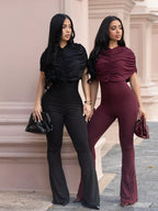 Ruched flare leg jumpsuit by Trendsi featuring a fitted bodice and flowy, flared legs in a stylish design.