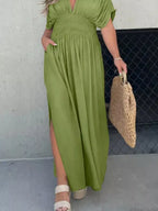Plus size maxi dress with slit, v-neck, smocked waist, full length, trendy design by Trendsi, perfect for casual or dressy occasions.