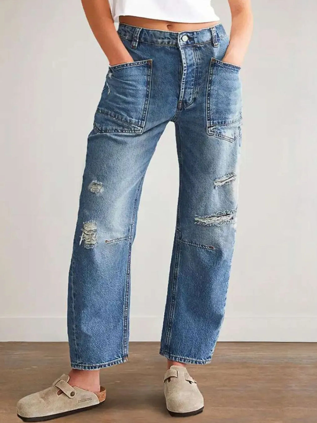 Distressed plush fashion denim jeans with front and back pockets, showcasing a trendy, worn-in look.