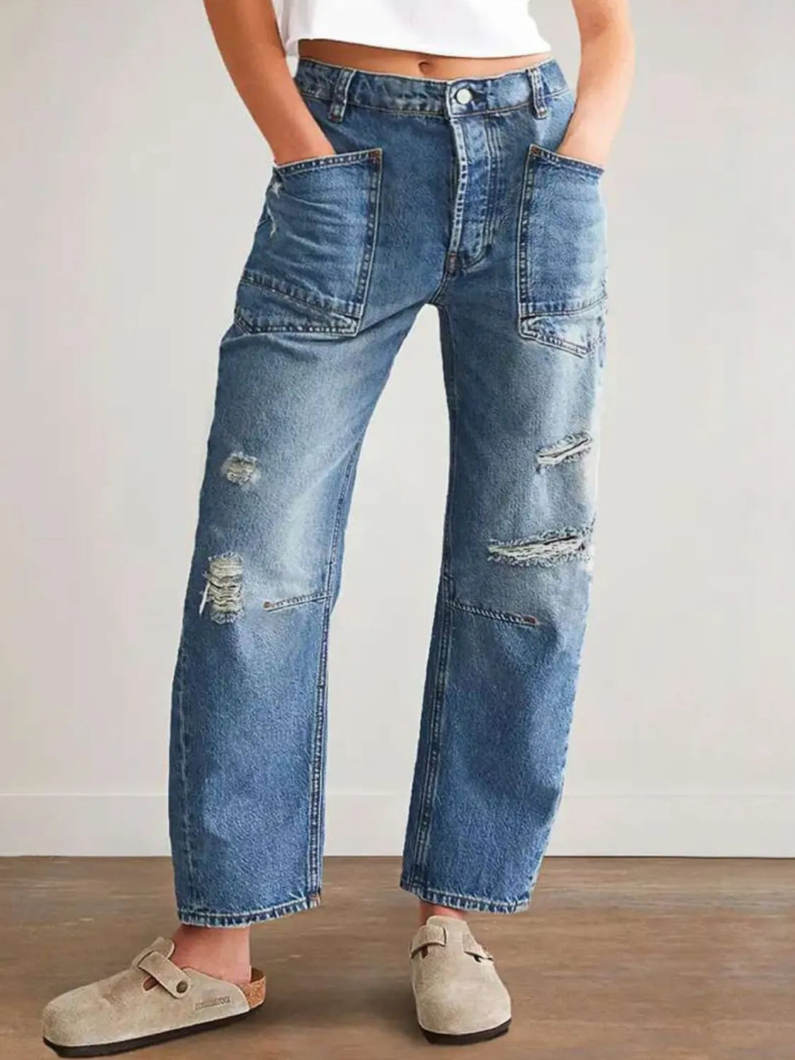 Distressed plush fashion denim jeans with front and back pockets, showcasing a trendy, worn-in look.