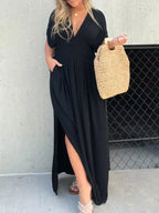 Plus size maxi dress with slit V-neck, smocked waist, and flowy fabric by Trendsi, shown in a full-length view.