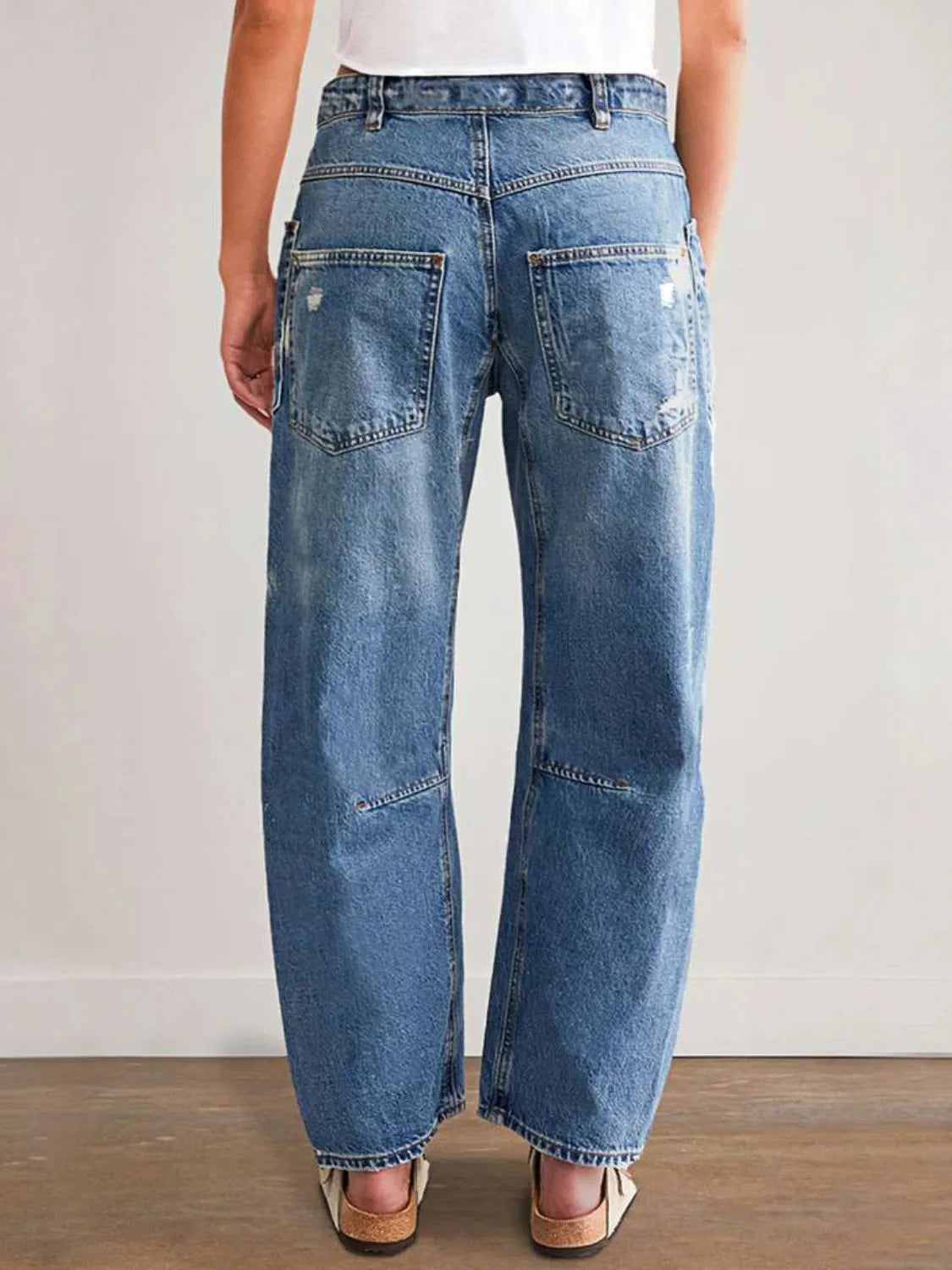 Distressed Plush Fashion Shop denim jeans with front and back pockets, featuring a trendy, ripped design and classic blue denim look.