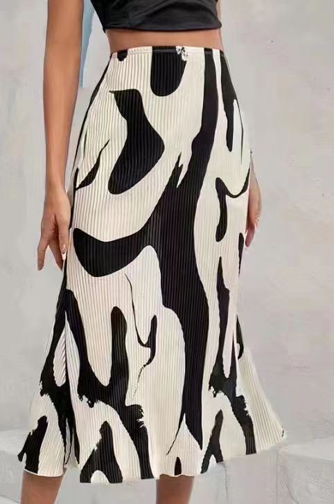 High-waisted, cream and black abstract-print pleated midi skirt paired with a black crop top.