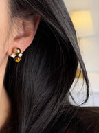Tiger Eye stud earrings by Trendsi featuring polished, round gemstone studs with gold-tone settings on a white background.