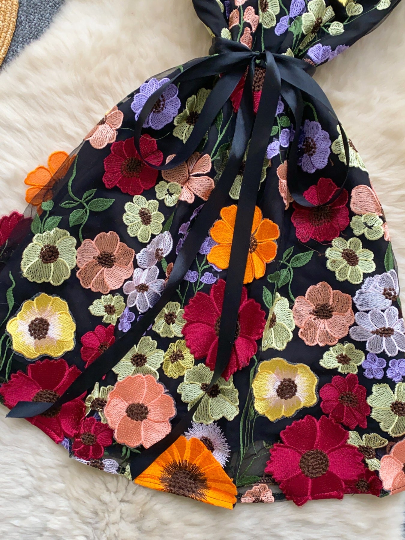 Floral embroidered tie waist mini dress by Trendsi featuring an elegant summer A-line design and colorful floral embroidery.