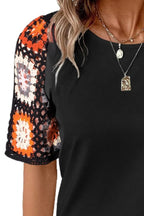 Geometric print round neck short sleeve blouse from Trendsi, stylish tops with vibrant geometric patterns and comfortable fit.