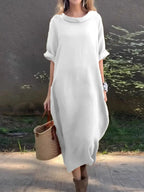 Full-length image of Plush Fashion Hub casual loose fit round neck midi dress with pockets, suitable for plus-size fashion.