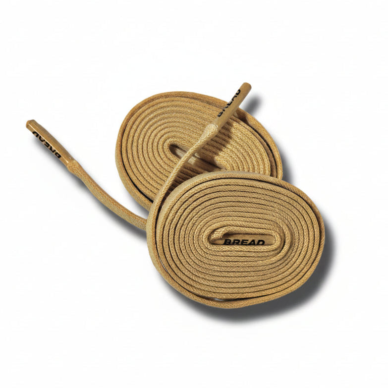 Desert tan Bread elastic shoelace with adjustable fit, showing smooth, flexible material and secure aglets for casual footwear.