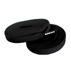 Black elastic shoelaces by Bread labeled Shadow Black, shown with the laces neatly threaded through shoe eyelets.