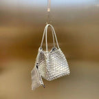 Hand-pressed woven tote bag from Plush Fashion Hub with sturdy handles and intricate woven design on natural material.