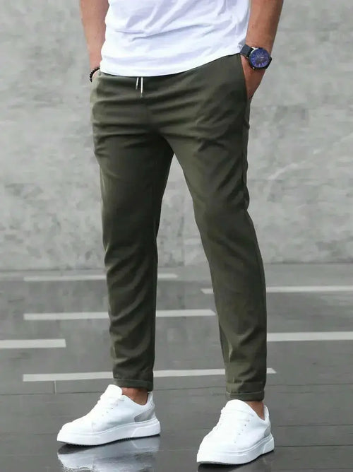 Men's slim fit casual drawstring trousers from Plush Fashion Hub, lightweight pants with pockets and a modern design.