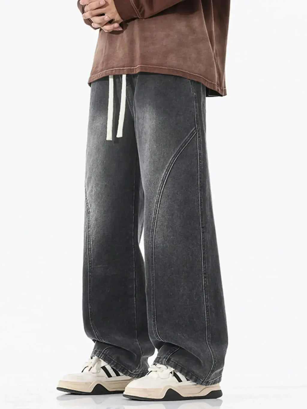 Men's vintage wash wide-leg drawstring jeans with relaxed fit in cotton denim, featuring visible stitching and a casual style.