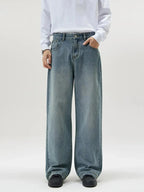 Men's vintage wash wide-leg jeans by Trendsi featuring relaxed fit, retro denim style, shown on a male model.